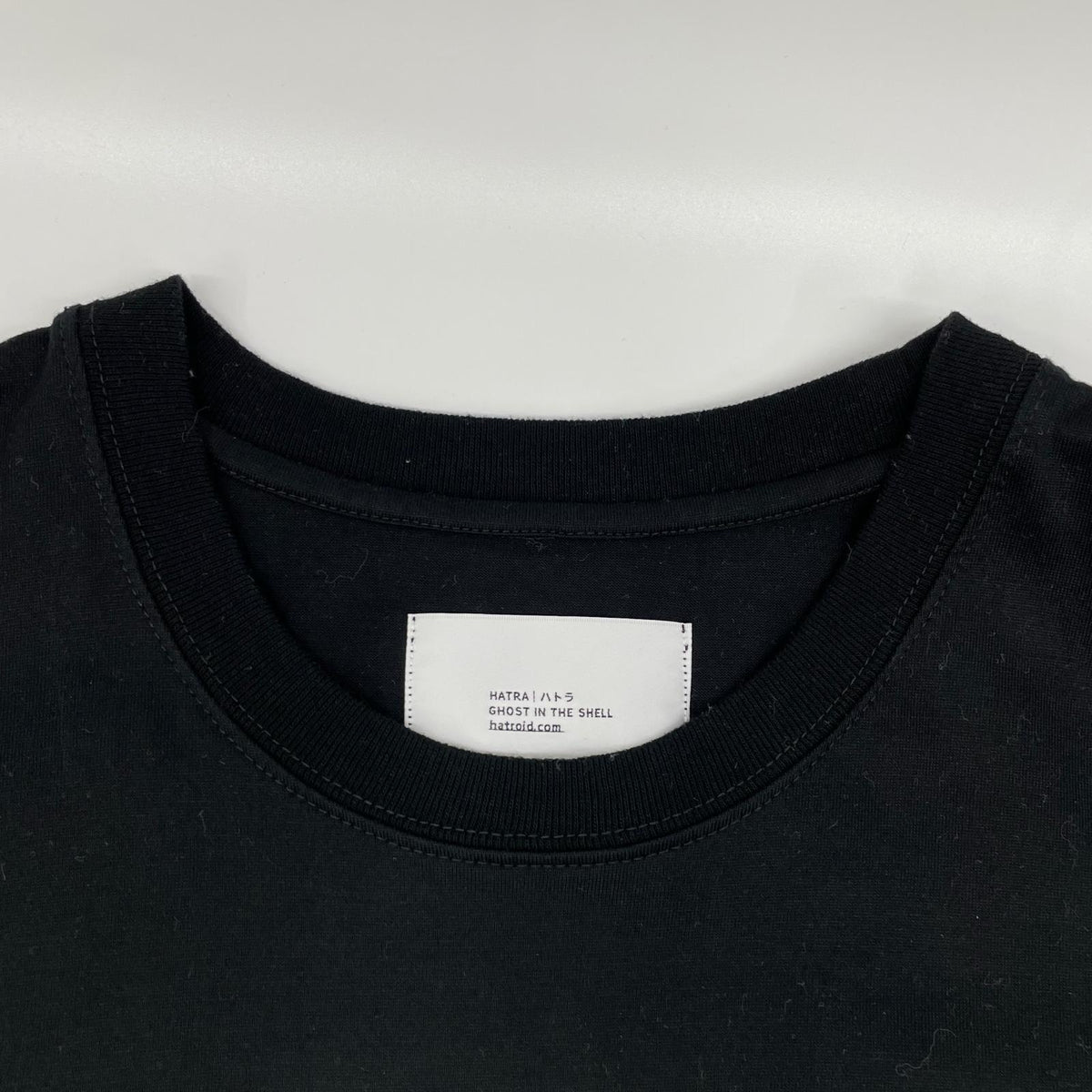 hatra ハトラ ブラック TS-Ghost GHOST IN THE SHELL タイトルロゴプリントTシャツ トップス